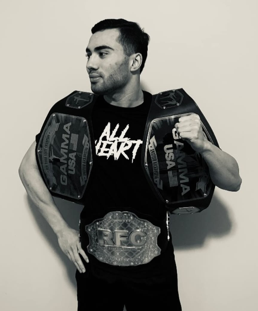 Matt All Heart Valencia wearing three championship belts